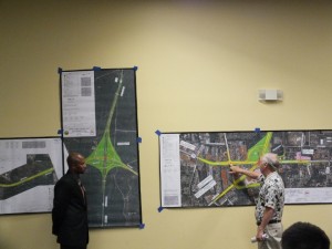 Cardinal Lanes bowling alley owner Fred Johnson (right) tells DOT staffer Jamille Robbins that a proposed Military Cutoff Road extension project could harm traffic flow to his business. (Port City Daily / Ben Brown)