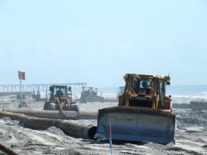 A federally aided widening of the Carolina Beach strand played out in spring 2013 with sand dredged from Carolina Beach Inlet. File photo by Ben Brown.