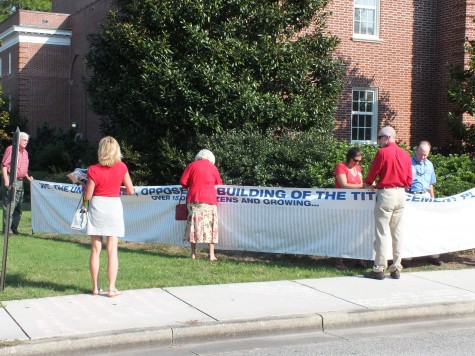 Opponents of the proposed Titan cement plant hang a banner petition with 15,000 signatures opposing the cement plant outside Monday's Division of Air Quality hearing. Photo by Caroline Curran.