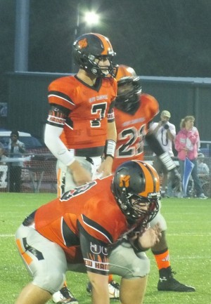 Ward Coleman (center), Grayson Bethal and Ramone Simpson (back) get ready to run a play. 