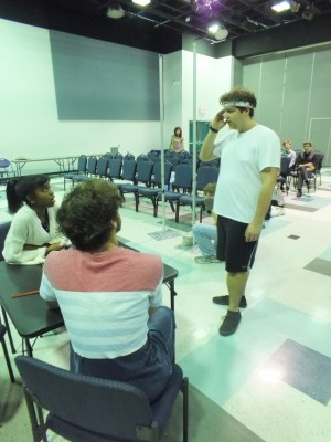 UNCW senior Zeb Mims, standing, talks to actors before rehearsals for 'YOLO' Monday. The play is one of two student-written and directed pieces featured in the upcoming production of 'The Write Stuff.' Photos by Hilary Snow. 