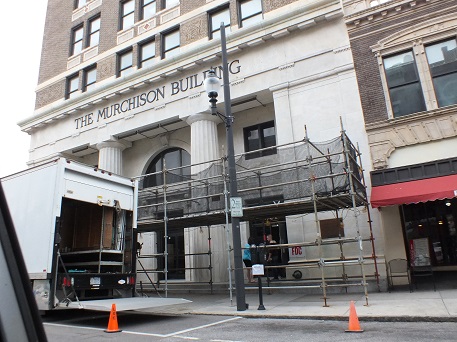 Trucks and crew for the 'The Sin Seer' indicate filming inside the Murchison Building.