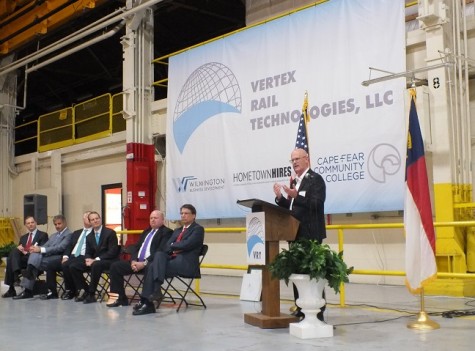 Vertex Rail CEO Don Croteau addresses attendees at Thursday's announcement, alongside N.C. Gov. Pat McCrory, Wilmington Business Development CEO Scott Satterfield, District Attorney Ben David, Transportation Secretary Tony Tata, Wilmington Mayor Bill Saffo and New Hanover County Commission Chairman Woody White, from right. Photo by Jonathan Spiers.