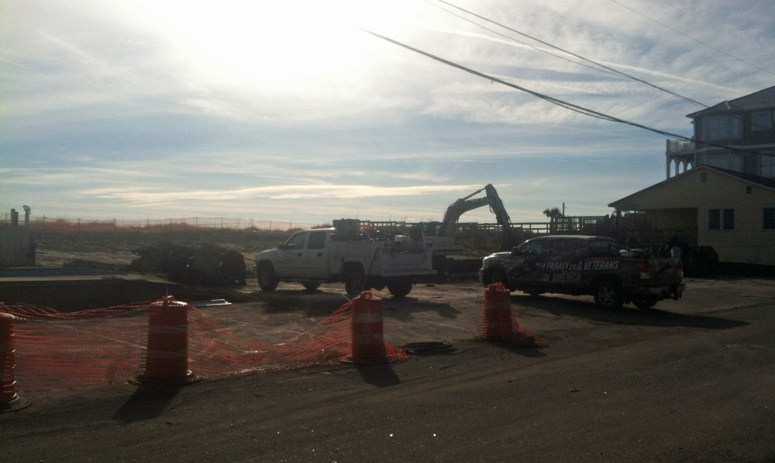 Crews clear the lot of what was once a condo unit at 409 Carolina Beach Ave. S. in Carolina Beach. The condo unit was destroyed in one of three fires Dec. 6. Photo by Caroline Curran.
