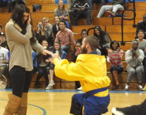 Laney tennis coach Beau Summersill brought the crowd to its feet with his halftime proposal. Photo by Joe Catenacci 