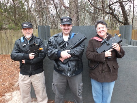 Locked and loaded - Battlefield Live Wilmington owners David and Maggie Chiprut and operator David Mark Chiprut, center, are ready to expand their mobile laser tag business with a permanent location. Photos by Hilary Snow.