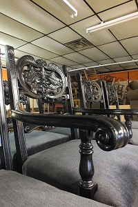 Set dressings include ornately carved tables and chairs.