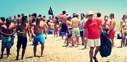 A volunteer with Masonboro.org collects trash on Masonboro Island on July 4. Photo courtesy Masonboro.org.