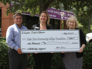 Rick DeCrescente, Alliance Credit Union's regional vice president and Kandra Romeo, Alliance business relationship manager, present a scholarship donation  to Dana McKoy, director of annual giving for the CFCC Foundation. 