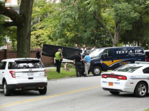 Wilmington police shield from onlookers the car in which a man was found fatally shot. Photo by Christina Haley, Port City Daily.