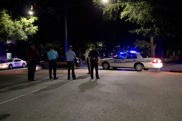 Authorities watch as negotiations take place with a man who shot himself inside a Third Street home on Wednesday. The man has since been identified by U.S. Marshals. Photo by Hanna Leyva.