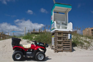 A Carolina Beach Ocean Rescue ATV in front of Lifeguard Stand 19 by the Boardwalk, one of the busiest access points in Carolina Beach. Photo by Hannah Leyva.