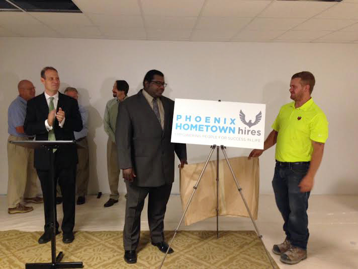 District Attorney Ben David, left, along with organization leaders, unveil the banner of a new organization to help those in need find jobs, Photo by Christina Haley.