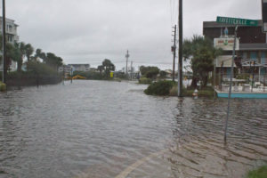 Carolina Beach Lake overflowed Monday morning due to high tides and heavy rain that fell overnight, causing Lake Park Boulevard to be closed down. Photo by Hannah Leyva