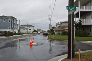 Water gushing out of a manhole at H Avenue and Fort Fisher Boulevard in Kure Beach on Monday. Photo by Hannah Leyva.