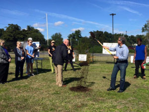 Wilmington Mayor Bill Saffo, second from right, and Vertex Railcar Corp. CEO Don Croteau break ground on the community garden at Portia Mills Hines Park on Oct. 31, 2015.