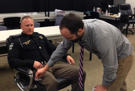 Robert Childs, with the N.C. Harm Reduction Coalition, administers a Naloxone dose to a sheriff's deputy during training. Photo by Christina Haley.