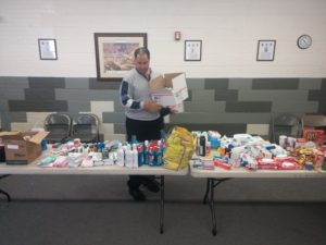 A volunteer fills a box for the latest Step up for Soldiers package drive. Photo by Aimee Bowen.