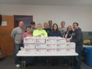 Volunteers and the packages they put together following the 2015 holiday drive.