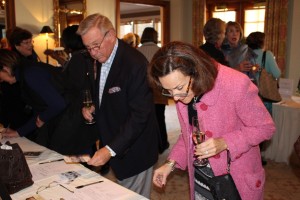 Guests at Friday's luncheon bid on silent auction items ahead of the three-course meal. The event, as well as a Thursday night dinner and auctions, helped raise more than $250,000 for GLOW.