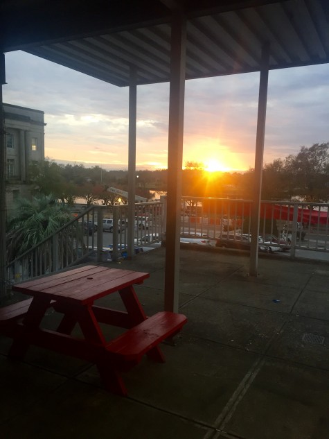 Sam's includes a back patio overlooking the river. 