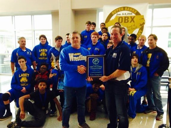 Coach Dan Willis accepts first-place trophy at this years OBX Tournament. Photo courtesy- Laney wrestling. 