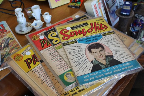 A signed copy Song Hits Magazine sits alongside an assortment of vintage toys and decor in one corner of Sullivan's wonderfully cluttered business.