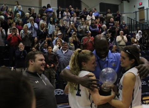 Hoggard seniors Emma Haywood, left, Coach Boubacar Aw, center, and Aleah Thompson. 