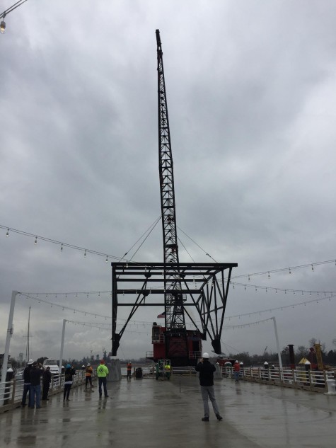 Crews work to lower the structure--70 feet long and 36 feet wide--onto the pier. The structure was constructed offsite and will be topped with a metal roof and covered in canvas.