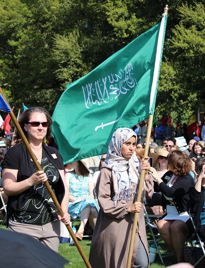 Students carry flags from their home countries during the installations processional. 