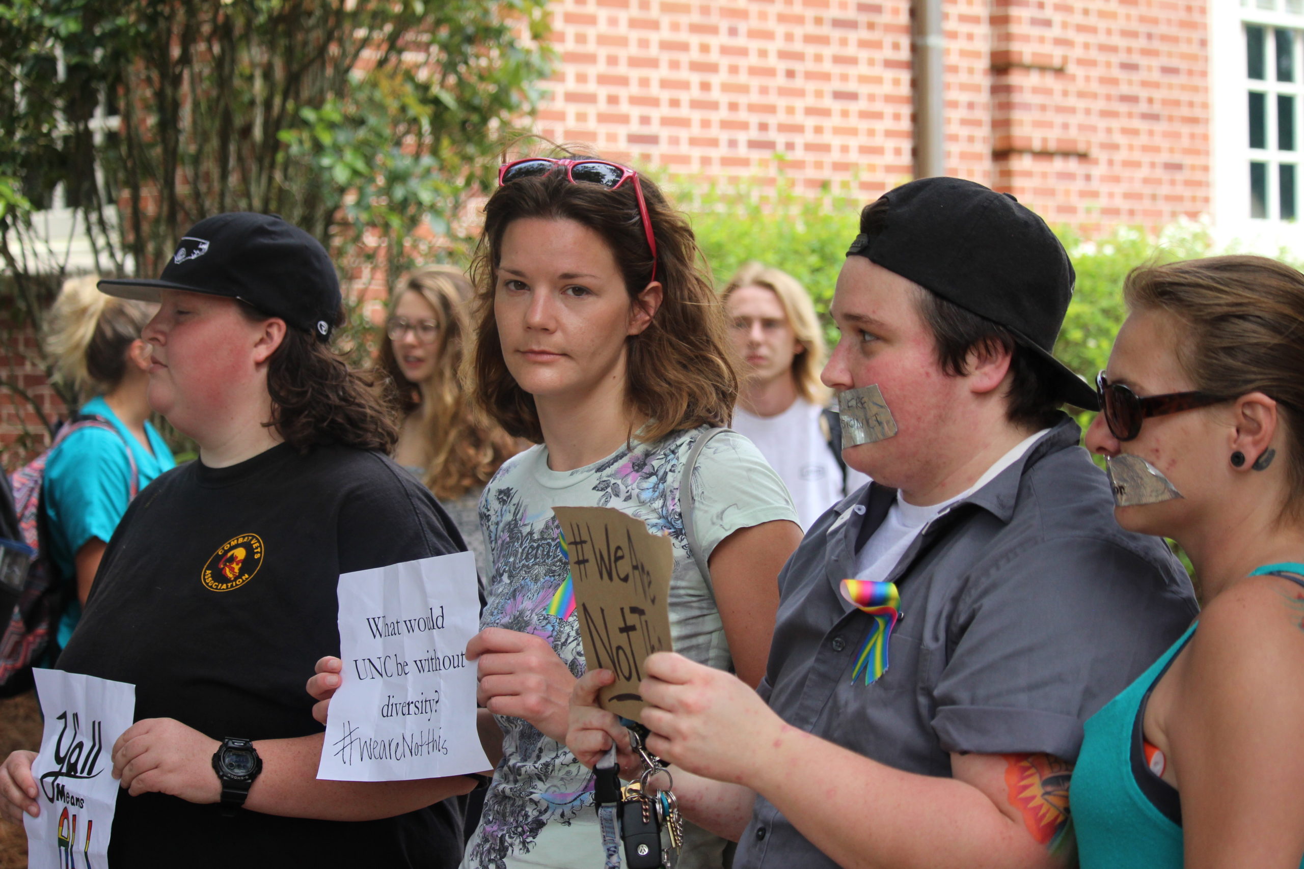 A small group gathered during at UNC-Wilmington yesterday during the chancellor installation ceremony to express opposition to House Bill 2. An organized rally is now underway at UNCW, followed by a second in midtown Wilmington tonight. Photo by Hilary Snow.
