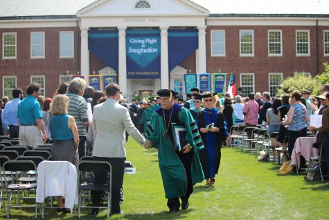 Sartarelli shakes hands with an audience member during the recessional. Hundreds of alumni, students, employees and community leaders turned out for Thursdays ceremony.