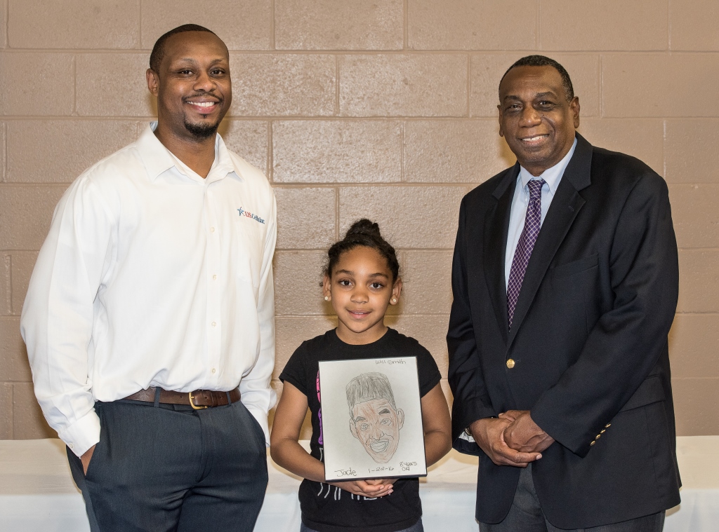 U.S. Cellulars Steven Westbrook, left, and Wilmington City Council member Earl Sherida pose with Jade Rivera, first place winner of this year's Black History Month art competition. Courtesy photos.