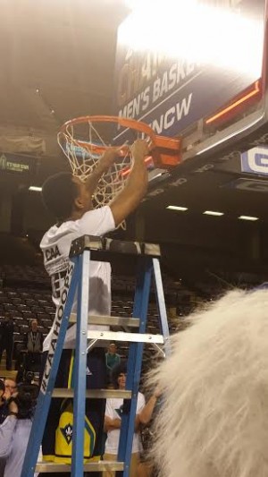 Senior Craig Ponder takes the first snip during the post game ceremony.