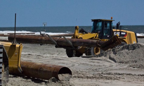 Pipes being laid out during beach nourishment in Carolina Beach, March 2016. (Port City Daily photo / FILE PHOTO)