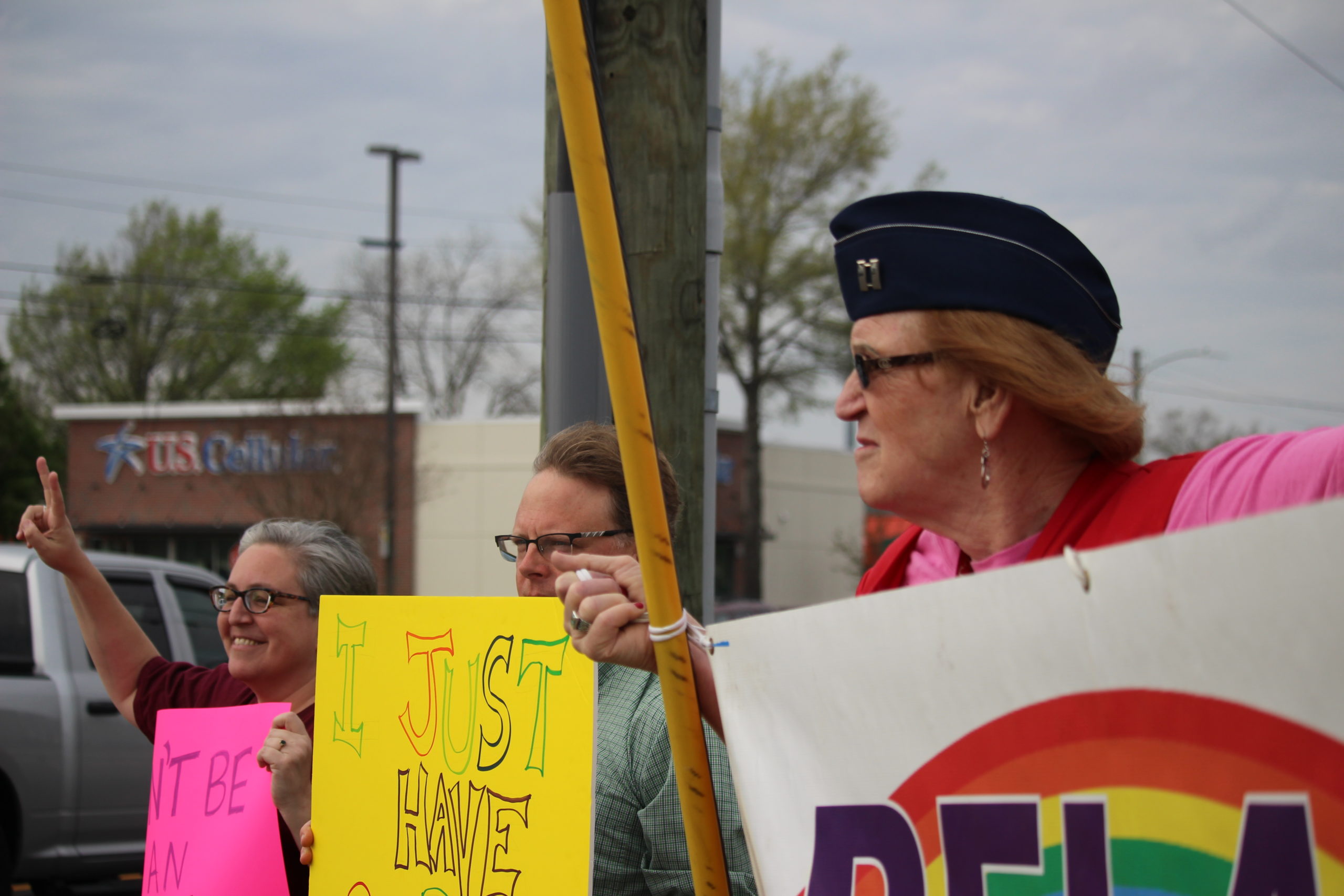 Rachael Gietchen, right, who transitioned in 2007 from a man to a woman, stands will fellow protesters along the intersection of College Road and Oleander Drive Friday. Photos by Hilary Snow.