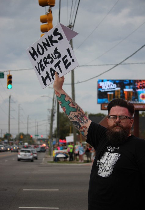 Calling on drivers to show support with their horns, rally participants received mostly honks and just a few hurtful remarks.