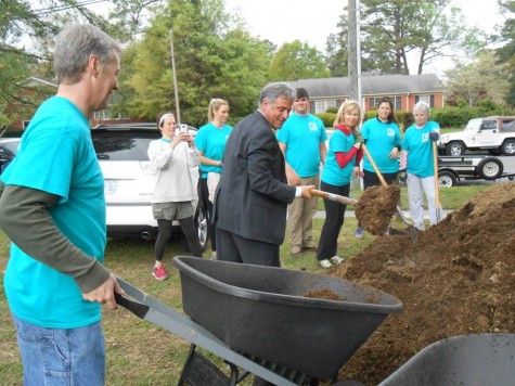 Wilmington Mayor Bill Saffo, a fellow realtor, gets his hands--and maybe his suit--dirty while helping build a community garden at St. John's Episcopal Church.