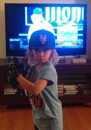 Ashtin Gerberg stands in front of the TV mimicking his favorite pitcher. Photos courtesy- Aaron Gerberg. 