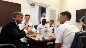 Mayor Bill Saffo, left, meets with the crew and commanding officer Gary Montalvo, right, of the submarine USS North Carolina. Photo by Hannah Leyva.
