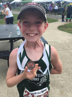 Gregor Brock showing off his hardware after competing in Maryland last summer. Photo courtesy- Larry Brock. 
