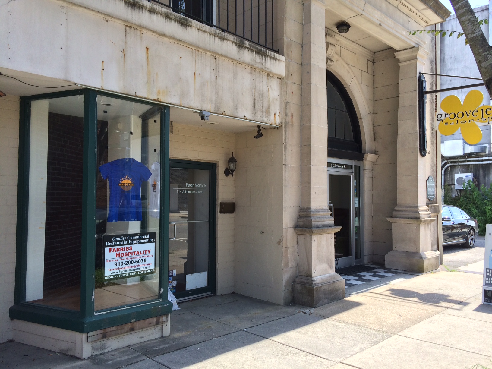 A Wake N Bake t-shirt hangs in the downtown storefront window of what will soon become the doughnut shop's second location. Photo by Christina Haley.