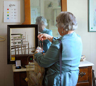 A thrifty customer looks through items at a Blue Moon estate sale. Local resident Andrea Barnes recently opened a Wilmington franchise of the Triangle-based company. Courtesy photos.