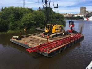 A floating crane on the port side of the Battleship North Carolina has been measuring water depth ahead of construction. Photo by Hannah Leyva.