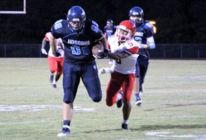 Hoggard Senior Patrick Morrison breaks a tackle on the way to a big gain on Friday.