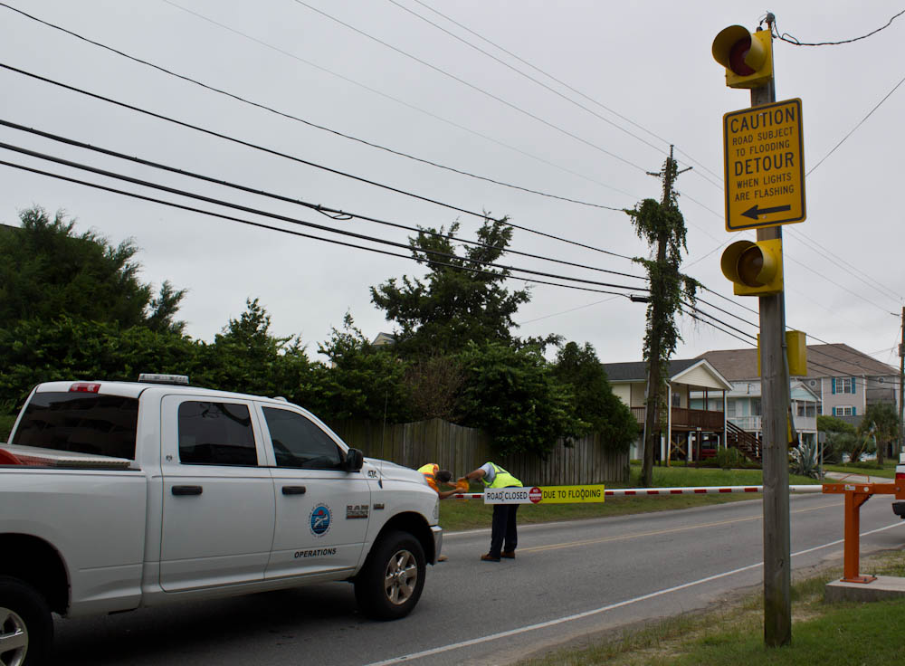 Carolina Beach employees checking lights on flood barricades Thursday morning ahead of Hurricane Matthew's arrival. Photo by Hannah Leyva.