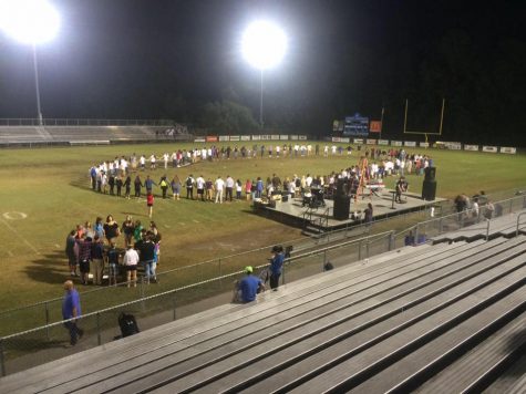 A group of students meet on the 50 yard line at Laney High School. 