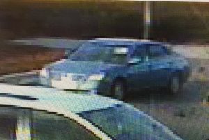 Police suspect the robber took off in this blue sedan. 