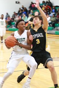 Brandon Parker, left, goes to the basket against Johnny Tartaglione. Photo courtesy- Joe Stanley. 
