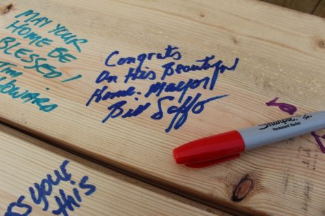 Mayor Bill Saffo's note on a 2x6 board to be used in the home.&nbsp;